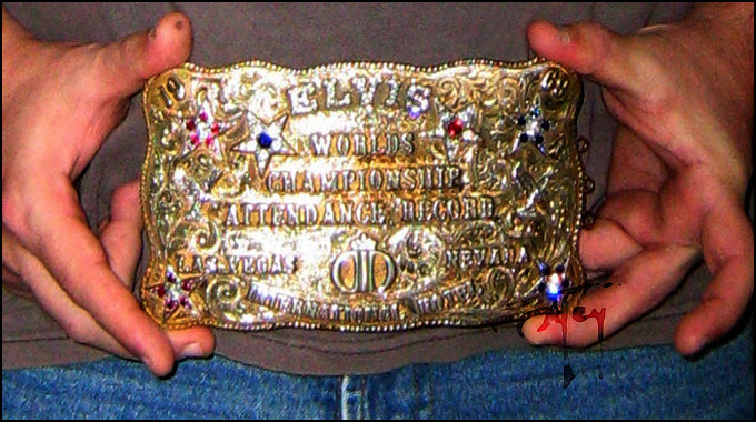 Holding Elvis Belt Buckle for scale